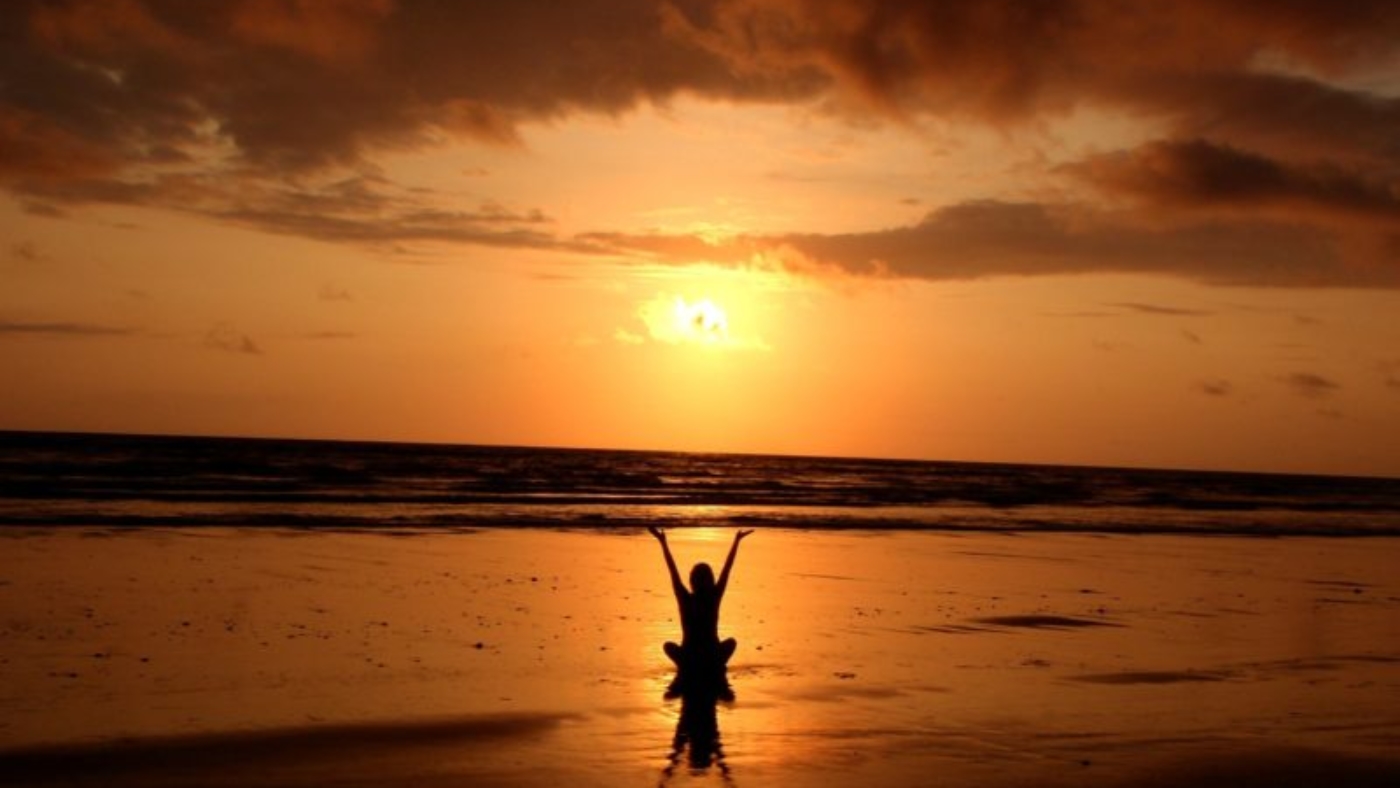 Sunset yoga sitting on beach