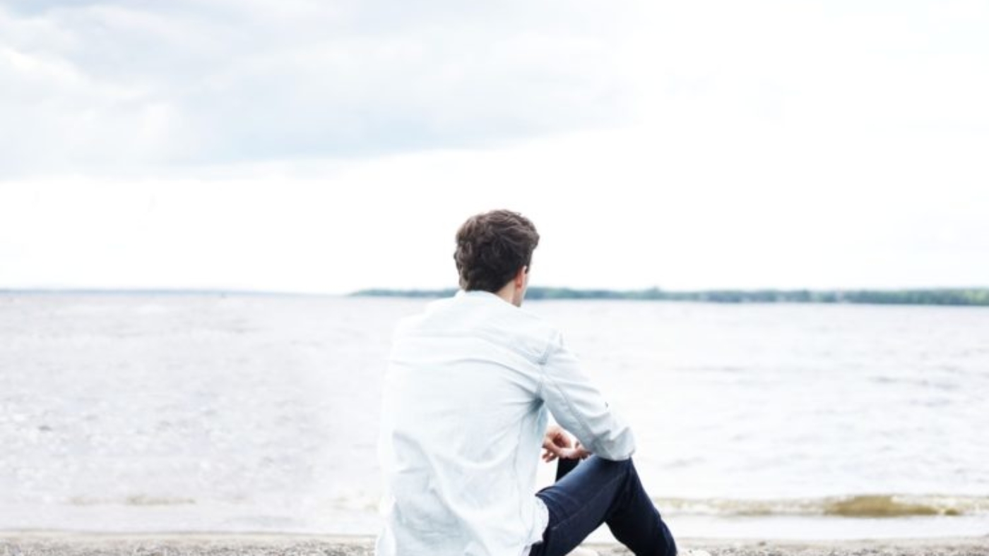 man self-reflecting on beach